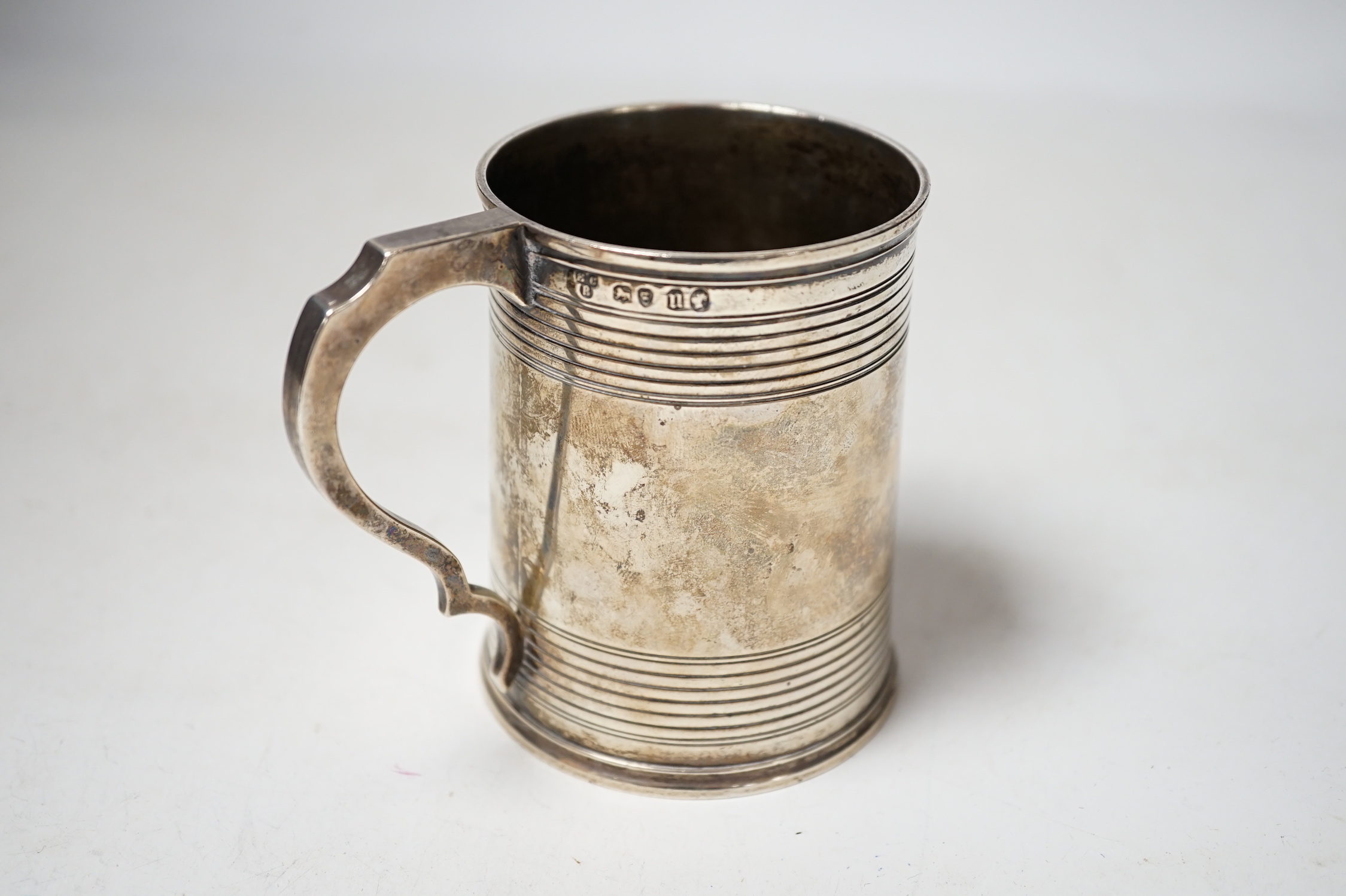 A Victorian reeded silver christening mug, Edward Charles Brown, London, 1868, 94mm.